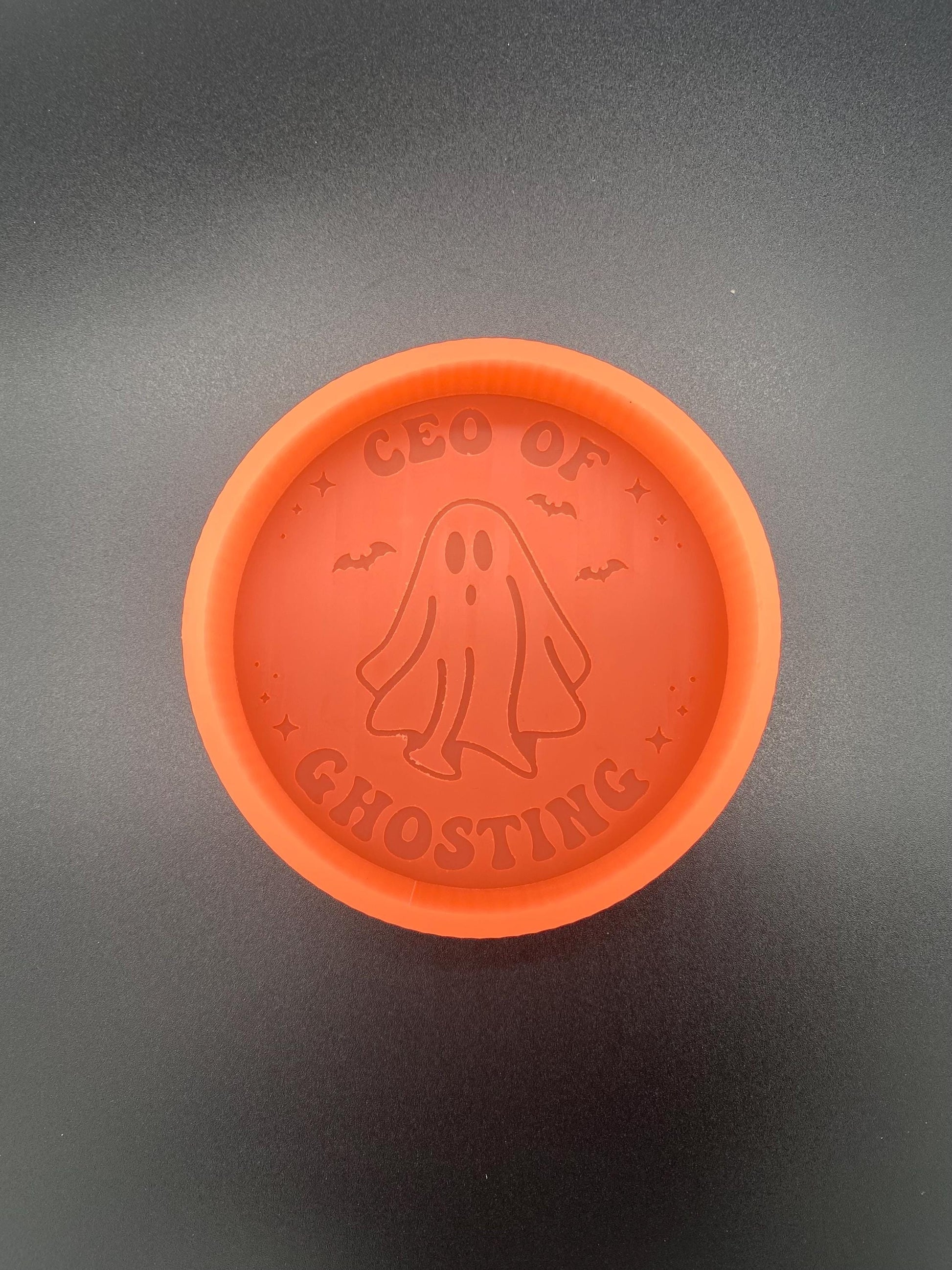 May include: Orange silicone mold with a ghost design and the text &#39;CEO OF GHOSTING&#39;.